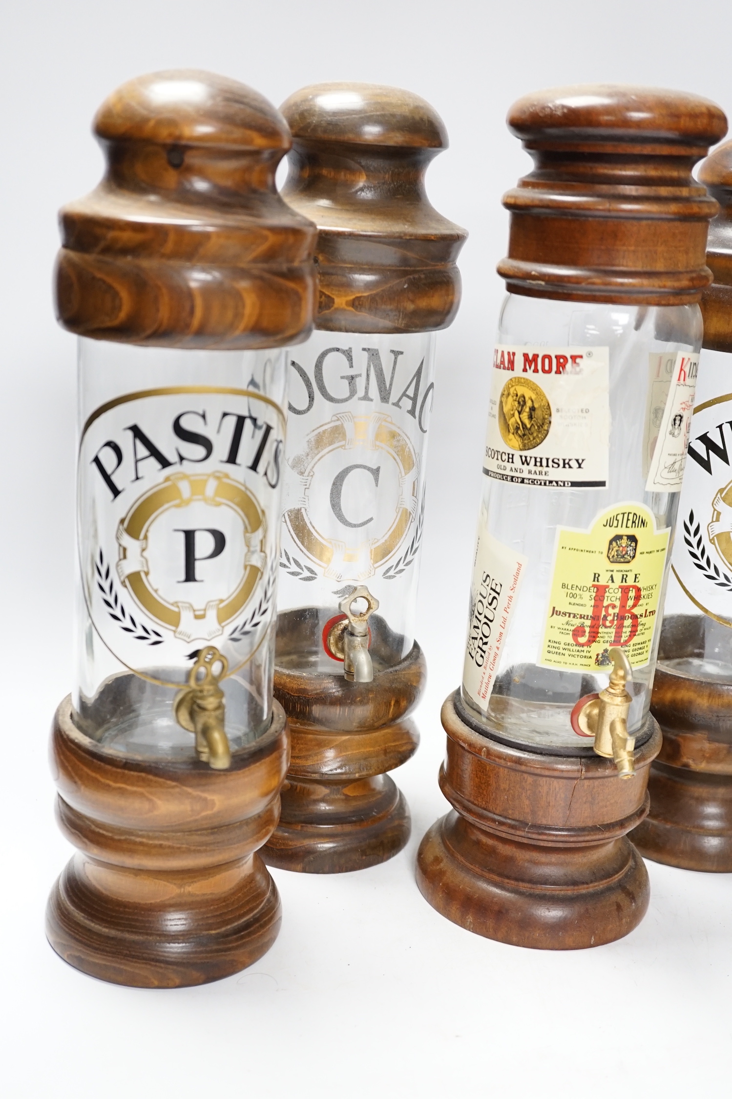 Four spirit vessels, whisky, pastis, cognac, and another, tallest, 38cm